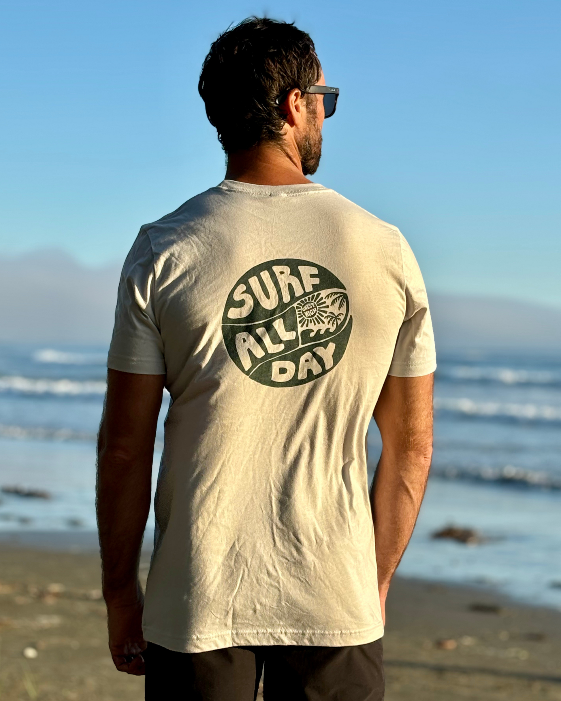 Surf all day graphic shirt at the beach.